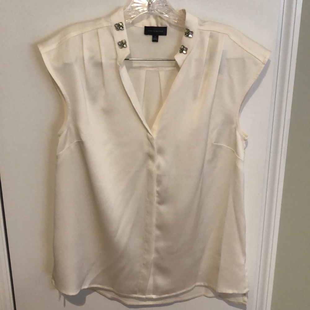 Cream colored shell with decorative neckline